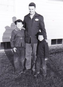 Sons Cliff (left) and Jeff greet their dad, Dave Stage (wearing his ESSO jacket), after a day at work.